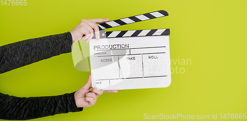 Image of movie clapper on green  background