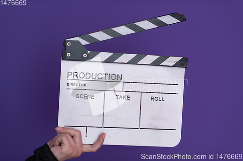 Image of movie clapper on purple background