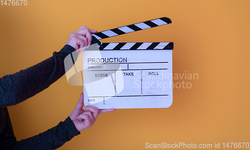 Image of movie clapper on yellow background