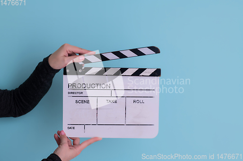 Image of movie clapper on cyan background