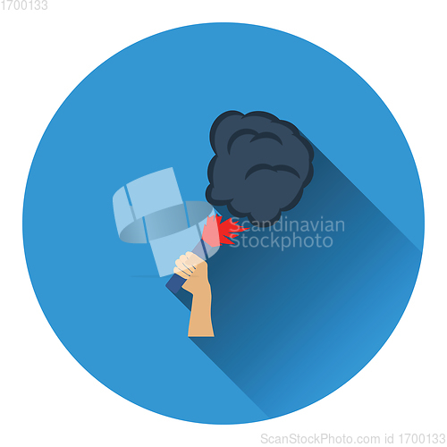 Image of Football fans hand holding burned flayer with smoke icon