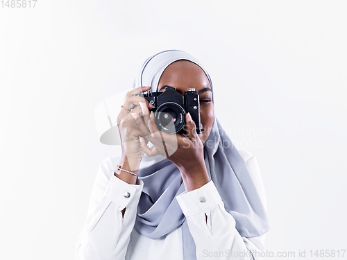 Image of african modern muslim woman using retro camera