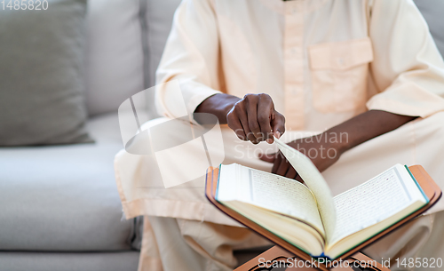 Image of african couple at home reading quran