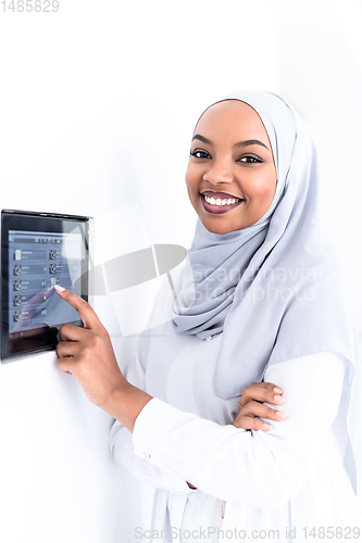 Image of african woman using smart home screen