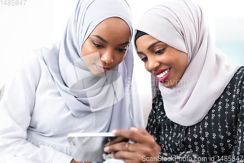 Image of african  women using smartphone at home