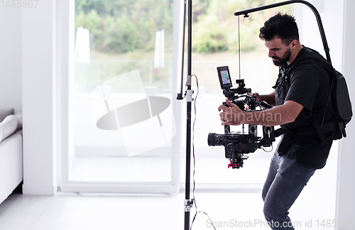 Image of Professional videographer with gimball video slr recording video