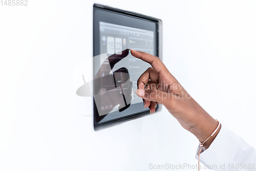 Image of african woman using smart home screen