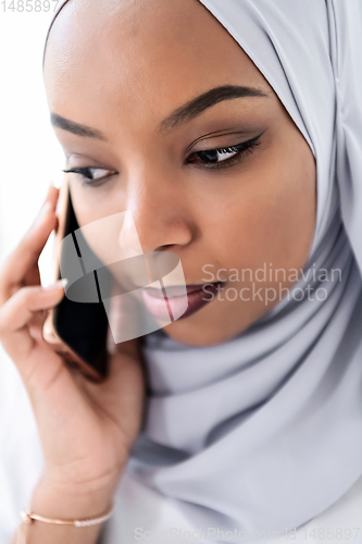 Image of african business woman using smartphone