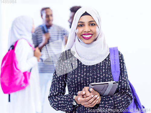 Image of muslim female student with group of friends