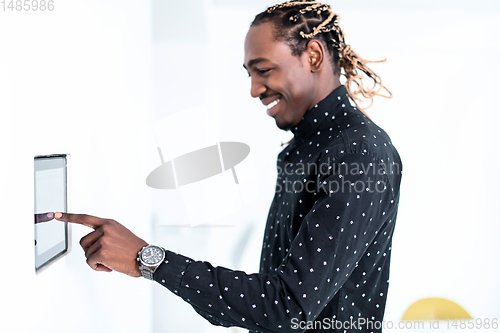 Image of African man using smart home screen