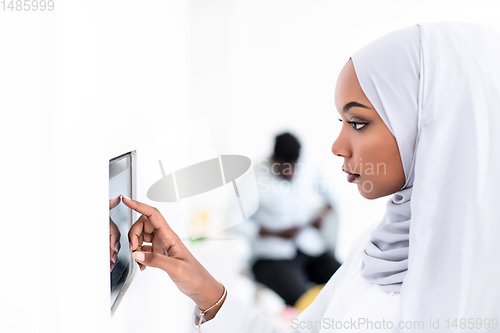 Image of african woman using smart home screen