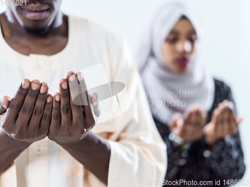 Image of african muslim couple praying