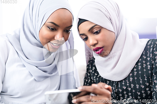 Image of african  women using smartphone at home