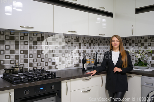 Image of Young woman at luxury modern white kitchen interior in provence style