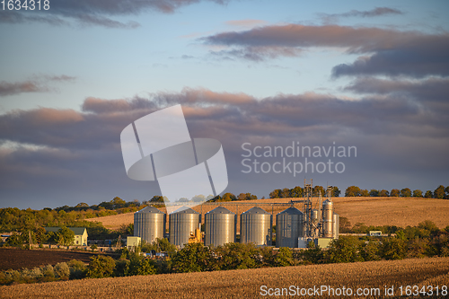 Image of Grain storage silos, shiny metal tanks for grain at Rogojeni railway station in Moldova