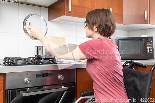 Image of disabled woman cooking in the kitchen