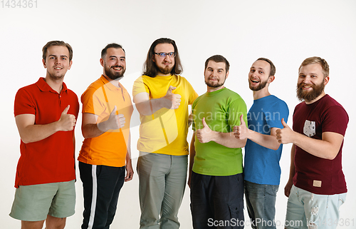 Image of Young men weared in LGBT flag colors isolated on white background, LGBT pride concept