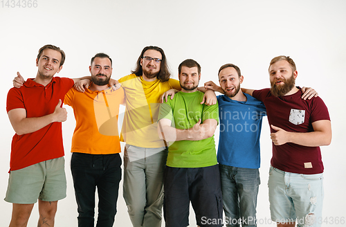 Image of Young men weared in LGBT flag colors isolated on white background, LGBT pride concept