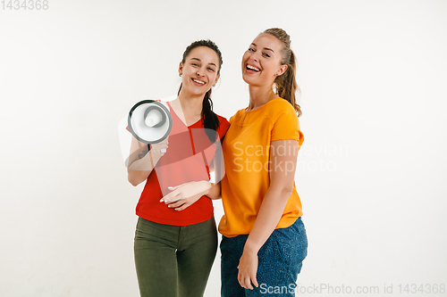 Image of Young women weared in LGBT flag colors isolated on white background, LGBT pride concept