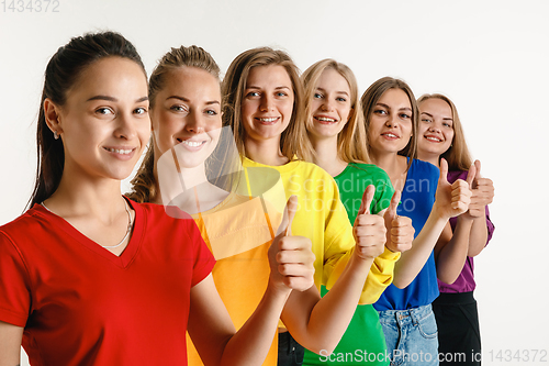 Image of Young women weared in LGBT flag colors isolated on white background, LGBT pride concept