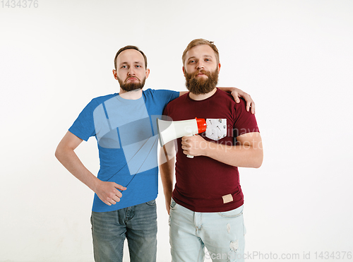 Image of Young men weared in LGBT flag colors isolated on white background, LGBT pride concept