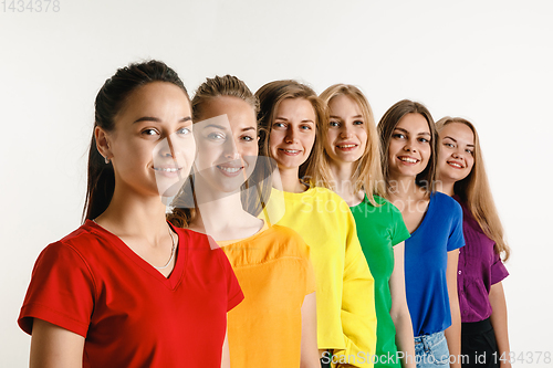 Image of Young women weared in LGBT flag colors isolated on white background, LGBT pride concept