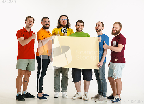 Image of Young men weared in LGBT flag colors isolated on white background, LGBT pride concept