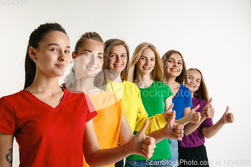 Image of Young women weared in LGBT flag colors isolated on white background, LGBT pride concept