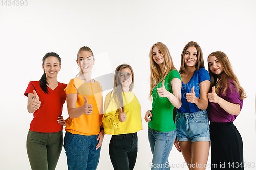 Image of Young women weared in LGBT flag colors isolated on white background, LGBT pride concept