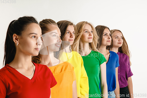 Image of Young women weared in LGBT flag colors isolated on white background, LGBT pride concept