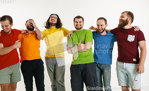 Image of Young men weared in LGBT flag colors isolated on white background, LGBT pride concept