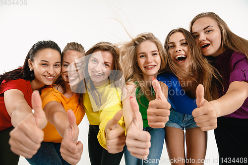 Image of Young women weared in LGBT flag colors isolated on white background, LGBT pride concept