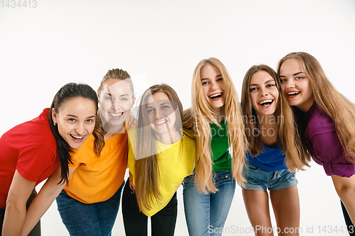 Image of Young women weared in LGBT flag colors isolated on white background, LGBT pride concept