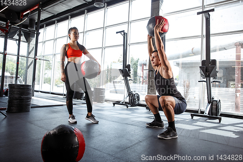 Image of A muscular athletes doing workout at the gym