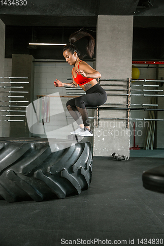 Image of A muscular female athlete doing workout at the gym