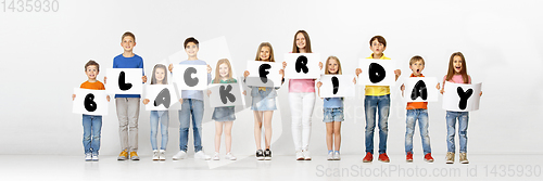 Image of Black friday, sales concept - childrens with the tables and letters