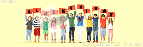 Image of Black friday, sales concept - childrens with the tables and letters