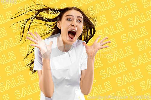 Image of Portrait of young woman on yellow background, black friday