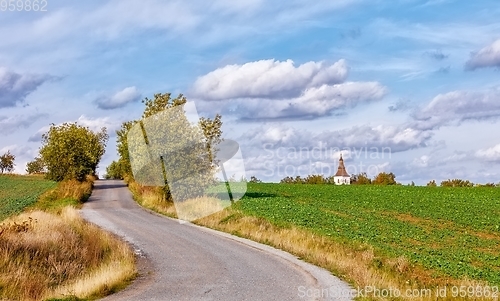 Image of rural road in the autumn with yellow trees