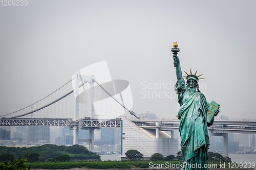 Image of Statue of liberty and tokyo cityscape, Japan