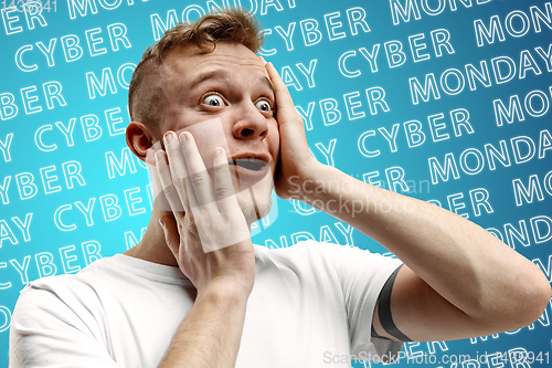 Image of Portrait of young man on blue background, black friday