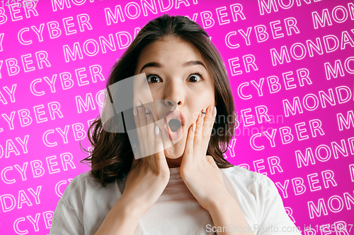 Image of Portrait of young woman on pink background, black friday