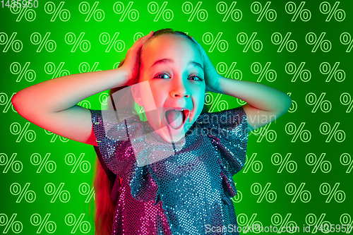Image of Portrait of little girl on green background, black friday