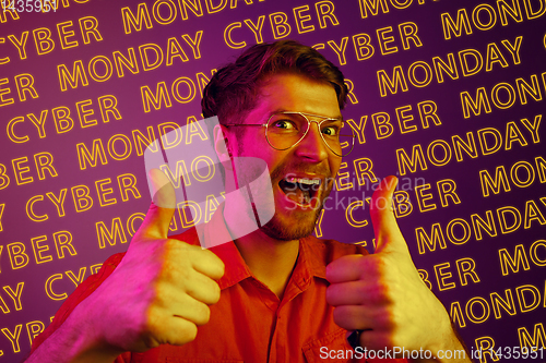 Image of Portrait of young man on purple background, black friday