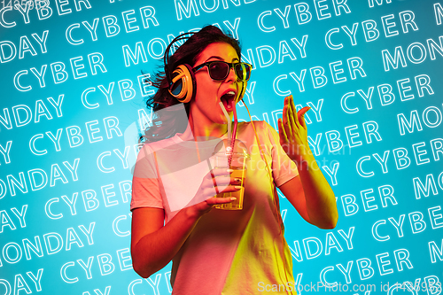 Image of Portrait of young woman on blue background, black friday