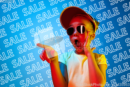 Image of Portrait of little girl on blue background, black friday