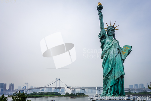 Image of Statue of liberty and tokyo cityscape, Japan