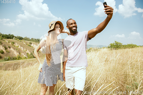 Image of Young multiethnic international couple outdoors