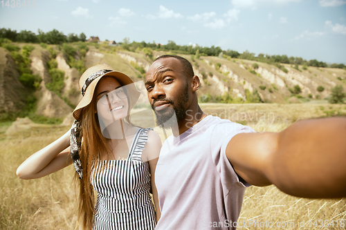 Image of Young multiethnic international couple outdoors