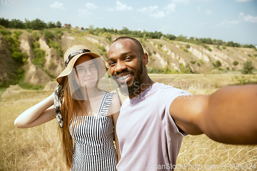 Image of Young multiethnic international couple outdoors